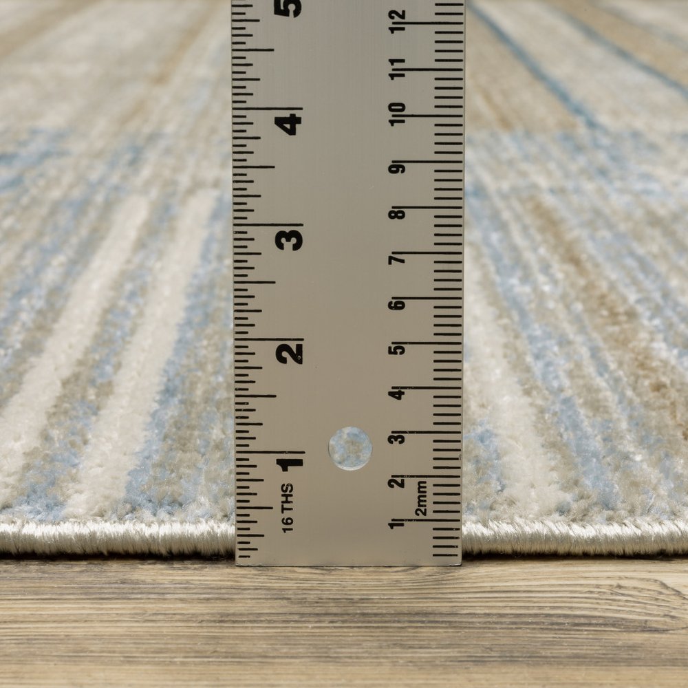 4' X 6' Blue Dark Blue Teal Grey Ivory Beige And Tan Geometric Power Loom Stain Resistant Area Rug With Fringe