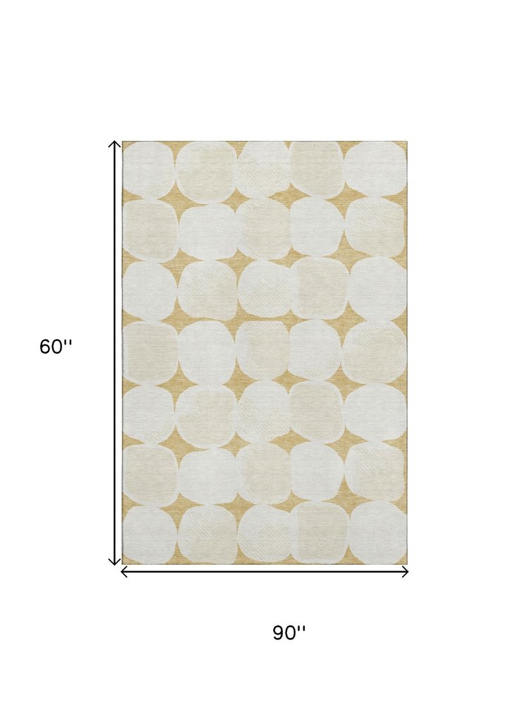 5' X 8' Gold And Ivory Abstract Geometric Washable Area Rug With UV Protection